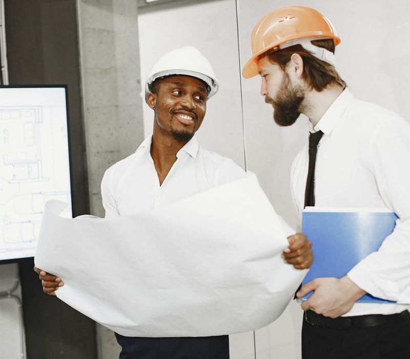 Professional construction management team in office discussing project plans